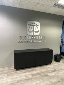 Buckhead Law Saxton Accident Injury Lawyers sign on the office wall