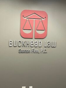 Buckhead Law Saxton Injury & Accident Lawyers, P.C. logo on the office wall