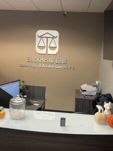Buckhead Law Saxton Accident Injury Lawyers, P.C., logo on the office wall