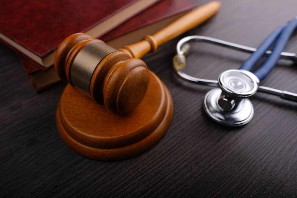 Gavel and stethoscope on wooden background