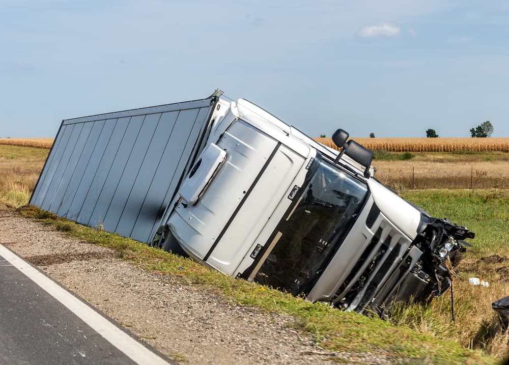 The large truck rests in a roadside ditch following the accident.






